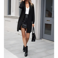 Black leather mini skirt with front slit paired with women’s long lightweight open collar suit jacket high waistband