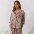 A soft oversized pink muted plaid button-down shirt with contrasting collar and pocket trim in a dressing gown plaid style