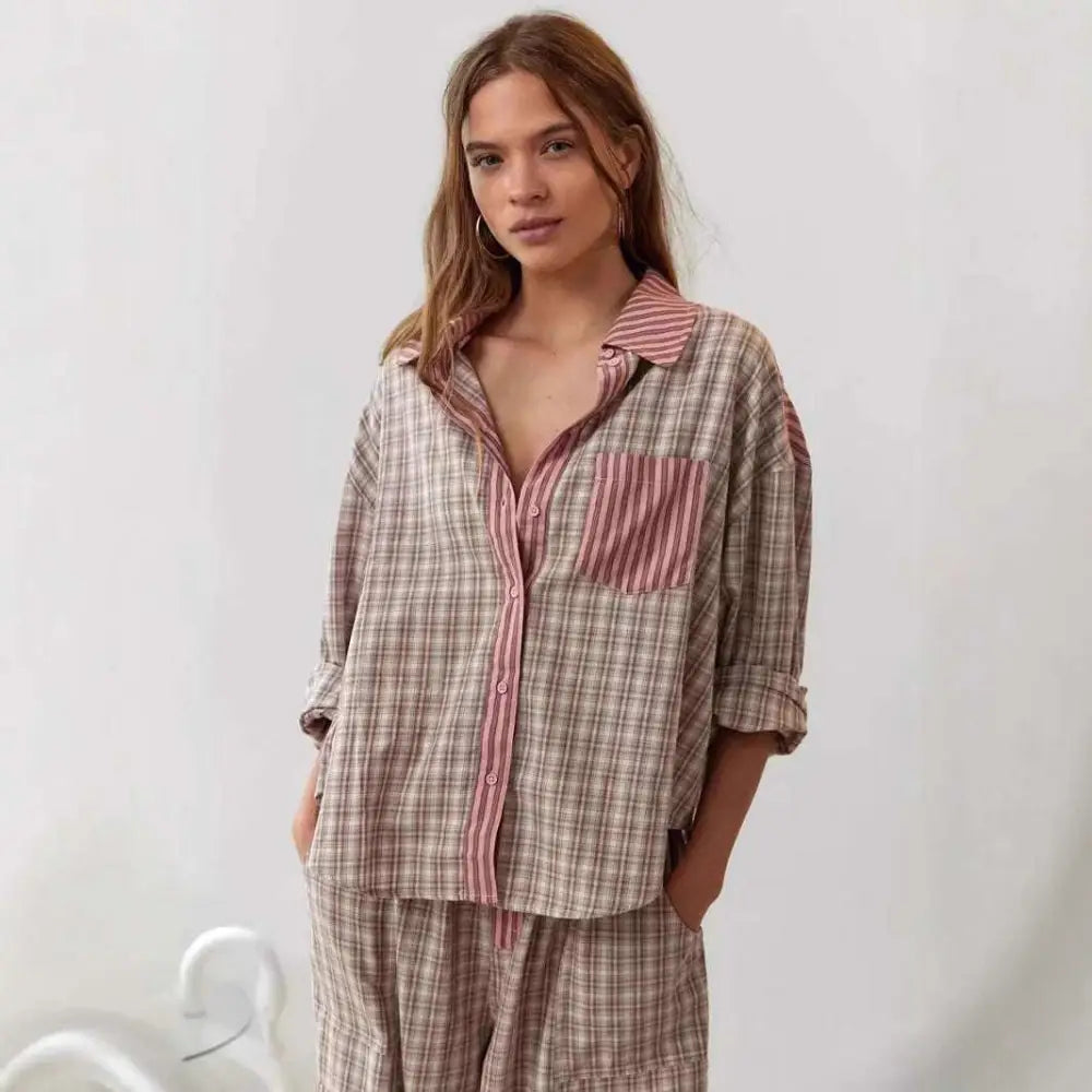 A soft oversized pink muted plaid button-down shirt with contrasting collar and pocket trim in a dressing gown plaid style