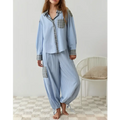 Women’s light blue striped pajama set with plaid patch pockets and cuffs complementing pink muted plaid dressing gown plaid
