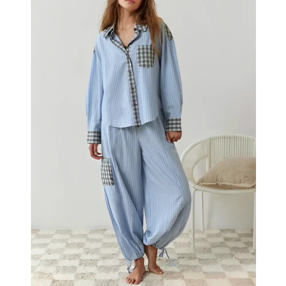 Women’s light blue striped pajama set with plaid patch pockets and cuffs complementing pink muted plaid dressing gown plaid