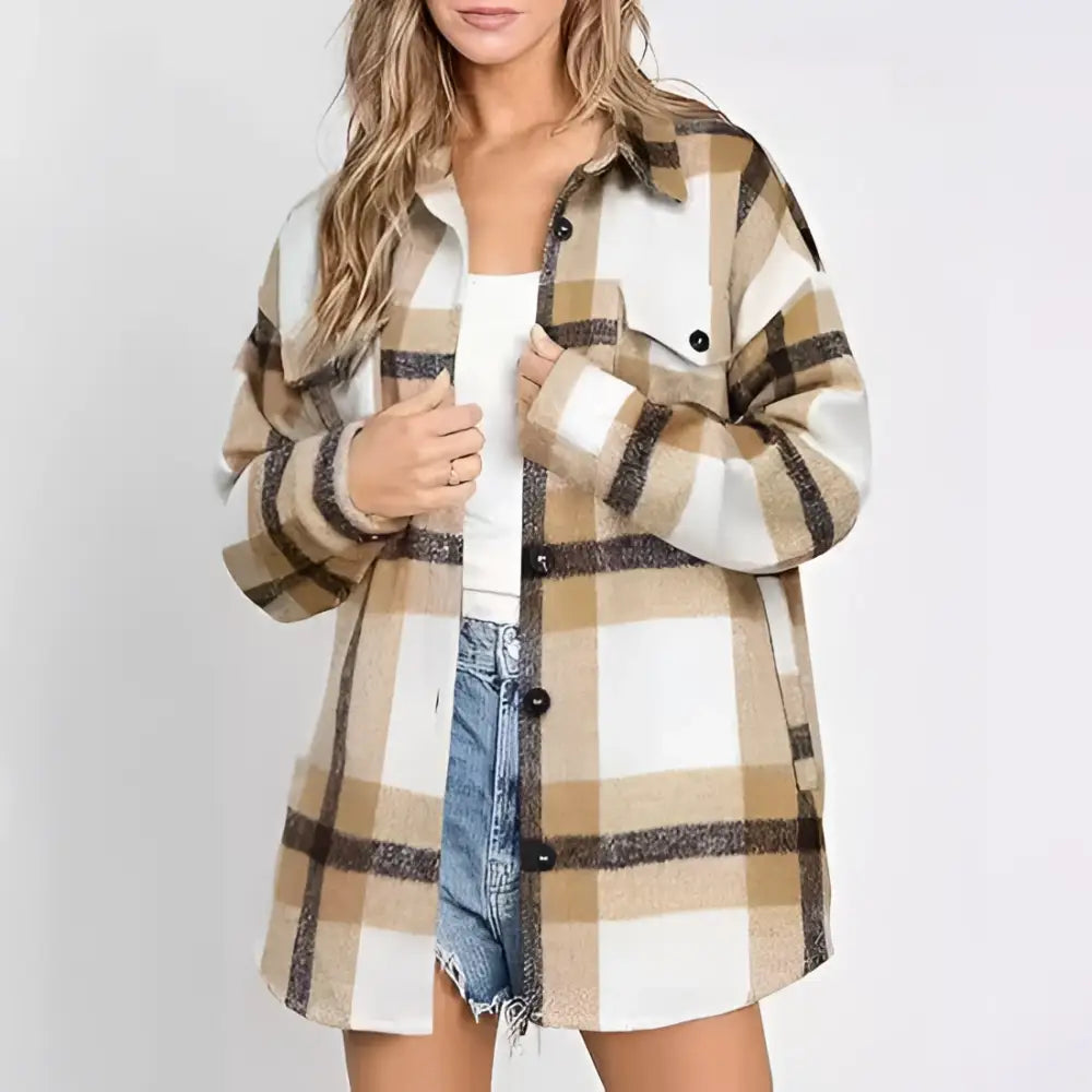 A women’s plaid buckle long sleeve jacket in beige and brown plaid flannel with an oversized button-up front