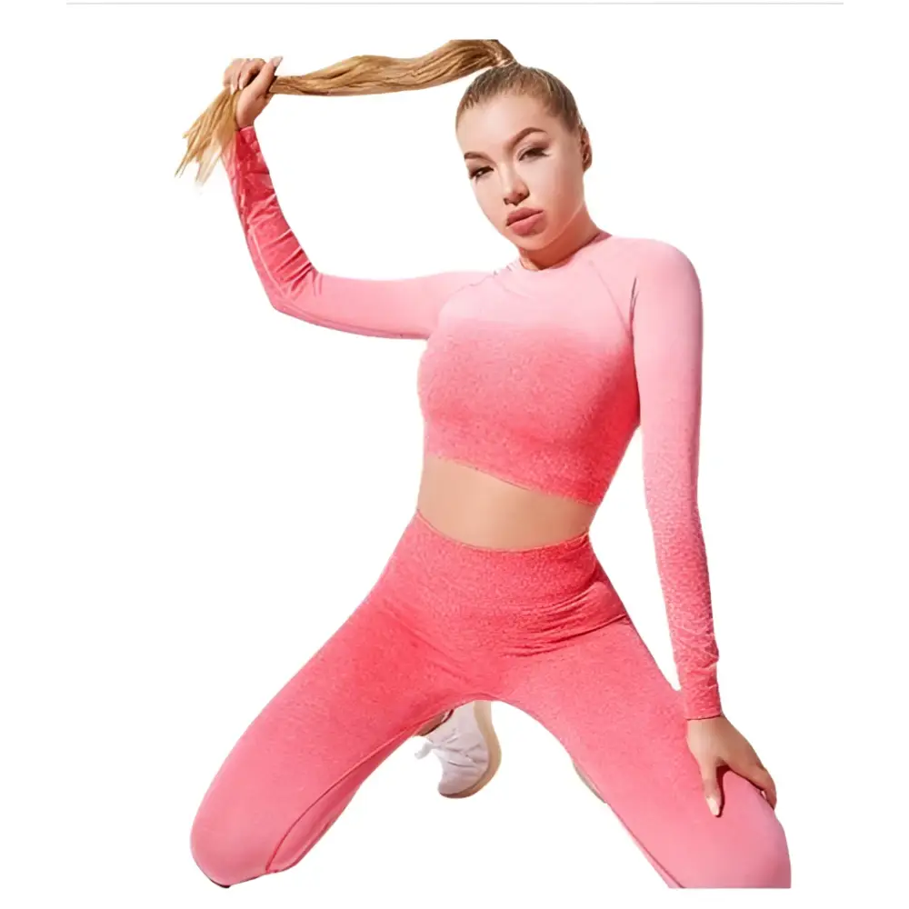 Women’s seamless gradient long sleeve yoga set in vibrant pink made from textured stretchy fabric featuring crop top and leggings