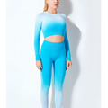 A vibrant blue seamless gradient long sleeve yoga set with a crop top and high-waisted leggings in stretchy fabric