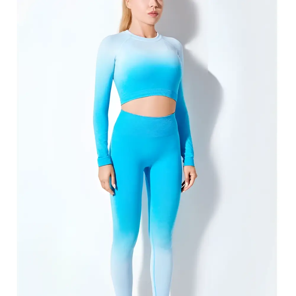 A vibrant blue seamless gradient long sleeve yoga set with a crop top and high-waisted leggings in stretchy fabric