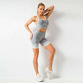 Gray heathered knit women’s seamless yoga two-piece workout set with white trim designed for hip lifting workout