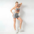 Women’s seamless yoga two-piece set in gray heathered and peach with stretchy fabric for hip lifting workout use