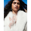 White faux fur coat with plush texture paired with long-sleeved women’s see-through lace floral mesh top and high neckline