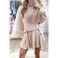A soft blush pink women’s solid colour ribbed knit casual suit with long sleeve top and flared skirt tied at the waist