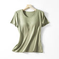 A soft olive green ribbed cotton women’s summerdale loose-fitting padded chest top with short sleeves on wooden hanger