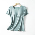 A soft mint green ribbed cotton women’s summerdale loose-fitting padded chest top with short sleeves on wooden hanger