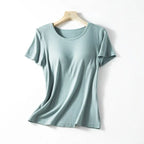 A soft mint green ribbed cotton women’s summerdale loose-fitting padded chest top with short sleeves on wooden hanger