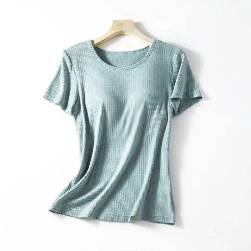 A soft mint green ribbed cotton women’s summerdale loose-fitting padded chest top with short sleeves on wooden hanger