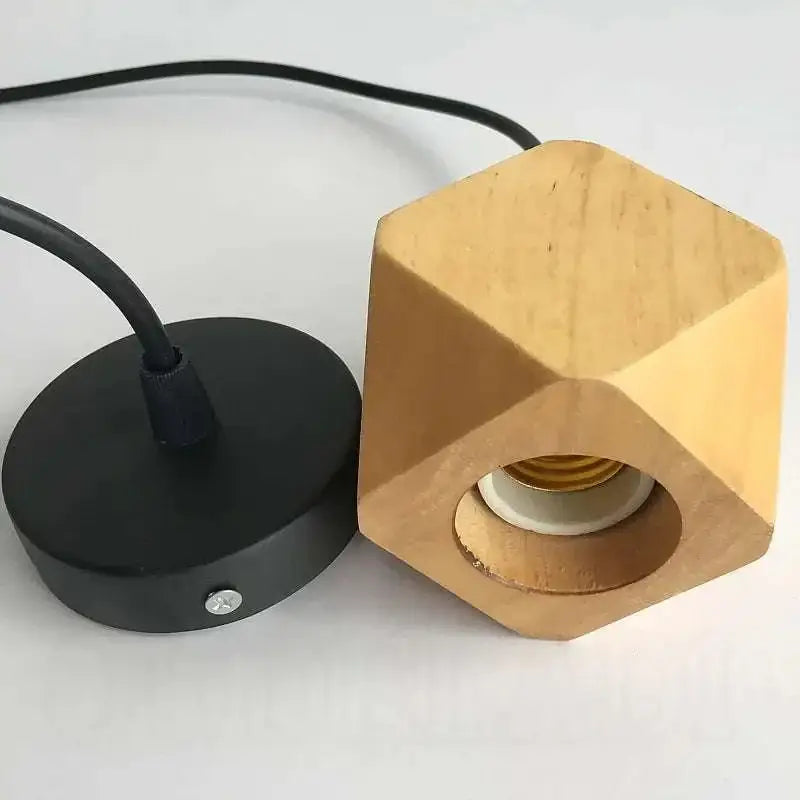 Minimalist hexagonal wood pendant light with natural finish and black metal base featuring edison glass bulb for living room
