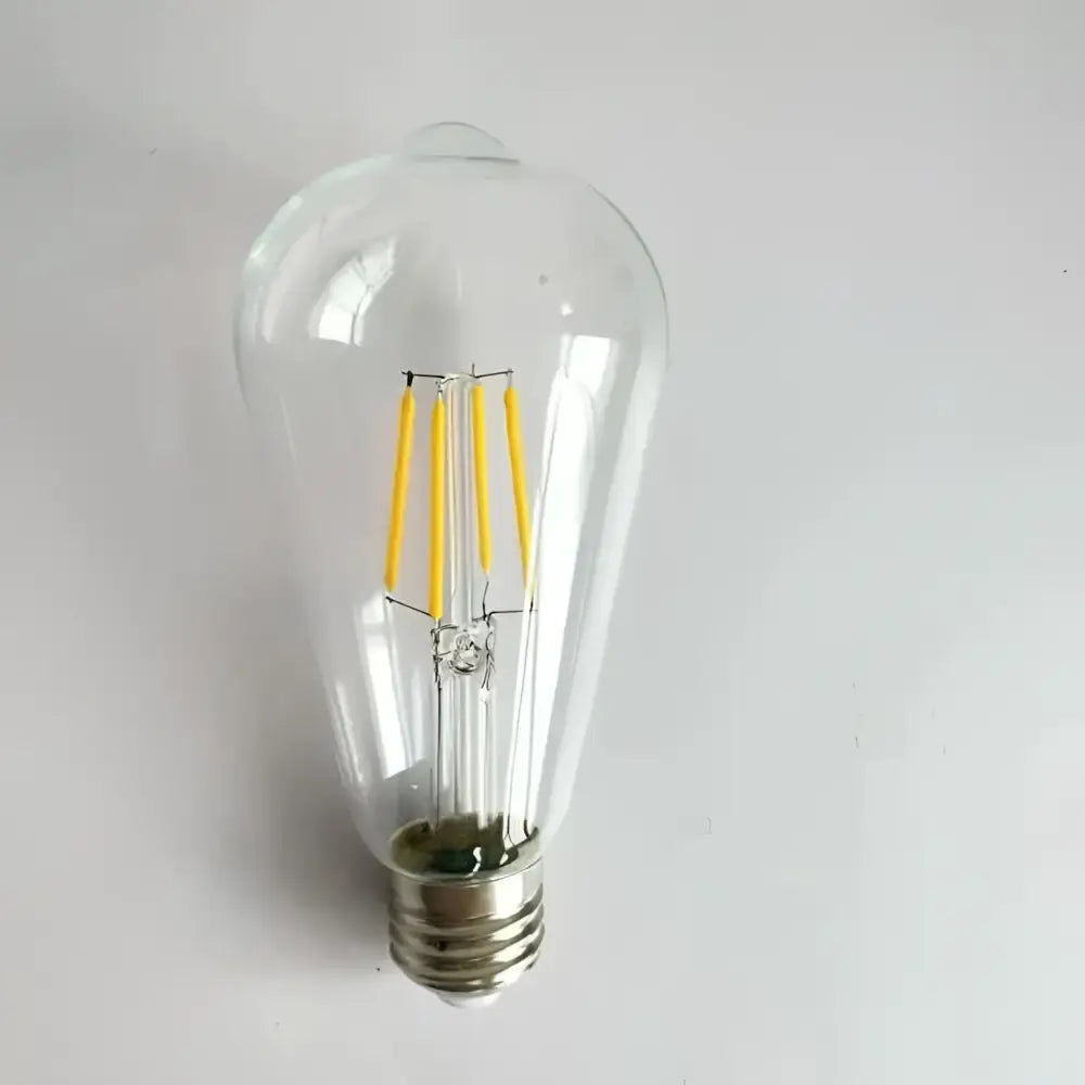 Clear glass edison glass bulb with four yellow led filaments and metallic base for wood pendant lights in living room