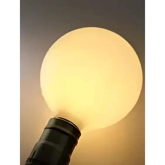 A warm glowing edison glass bulb with matte finish and black base in wood pendant lights for living room lighting