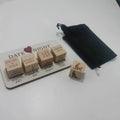 White wooden date night dice game board with engraved options and red heart with wooden dice cubes for couples