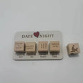 White wooden date night dice game board with four labeled activity cubes and a couple illustration cube for date night dice