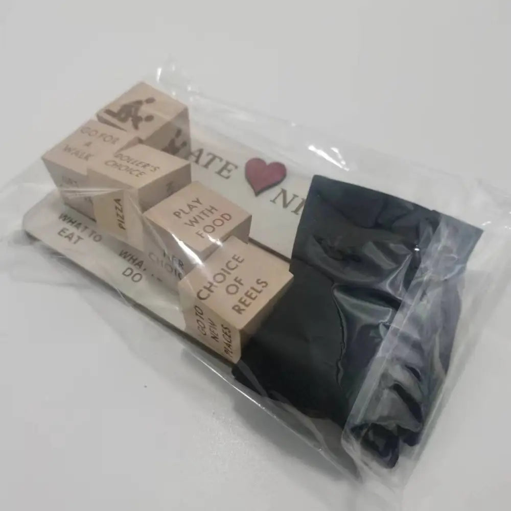 Wooden date night dice game board with engraved wooden cubes featuring phrases, packaged with black fabric in clear bag
