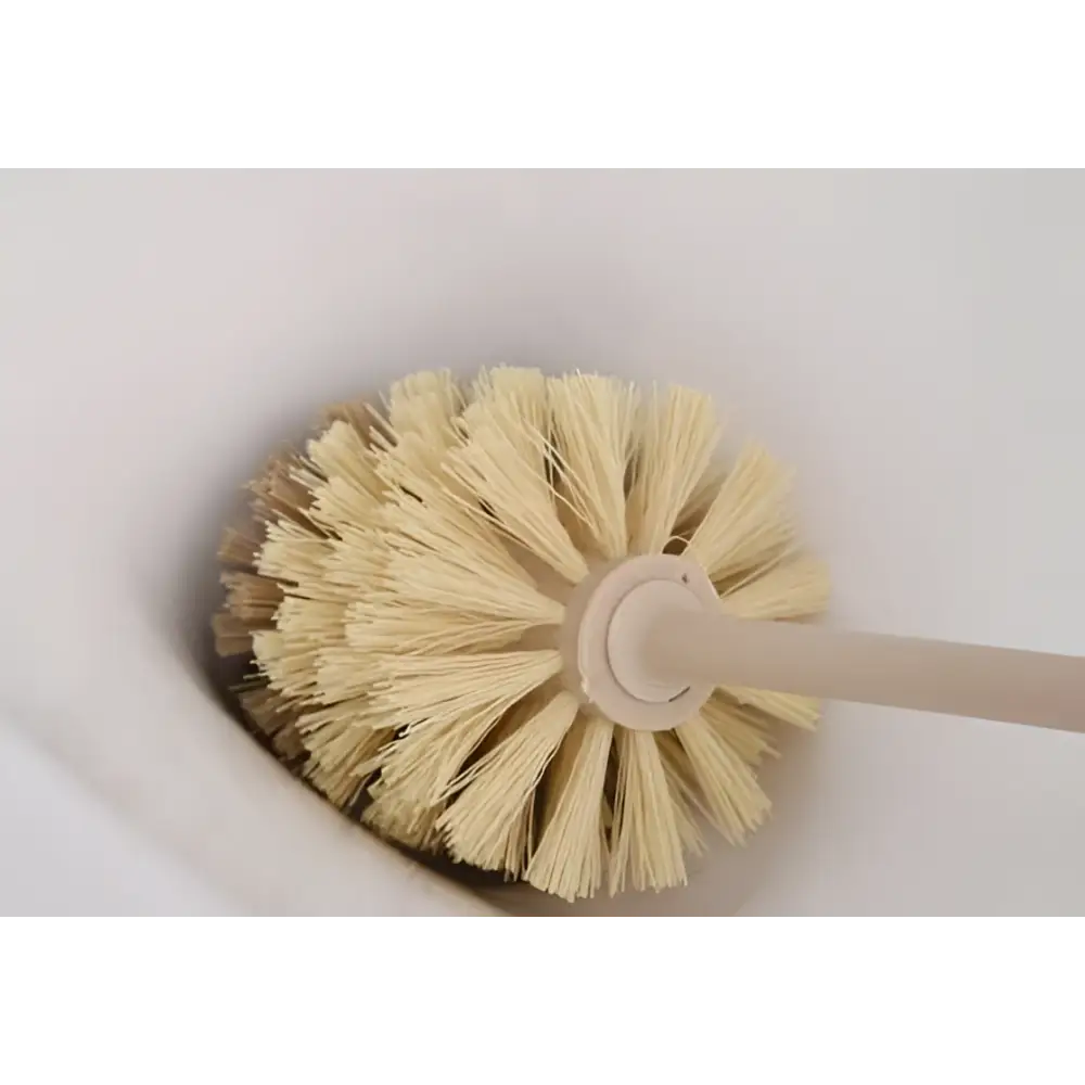 Beige cleaning toilet brush with soft bristles and wooden household handle for effective bathroom cleaning