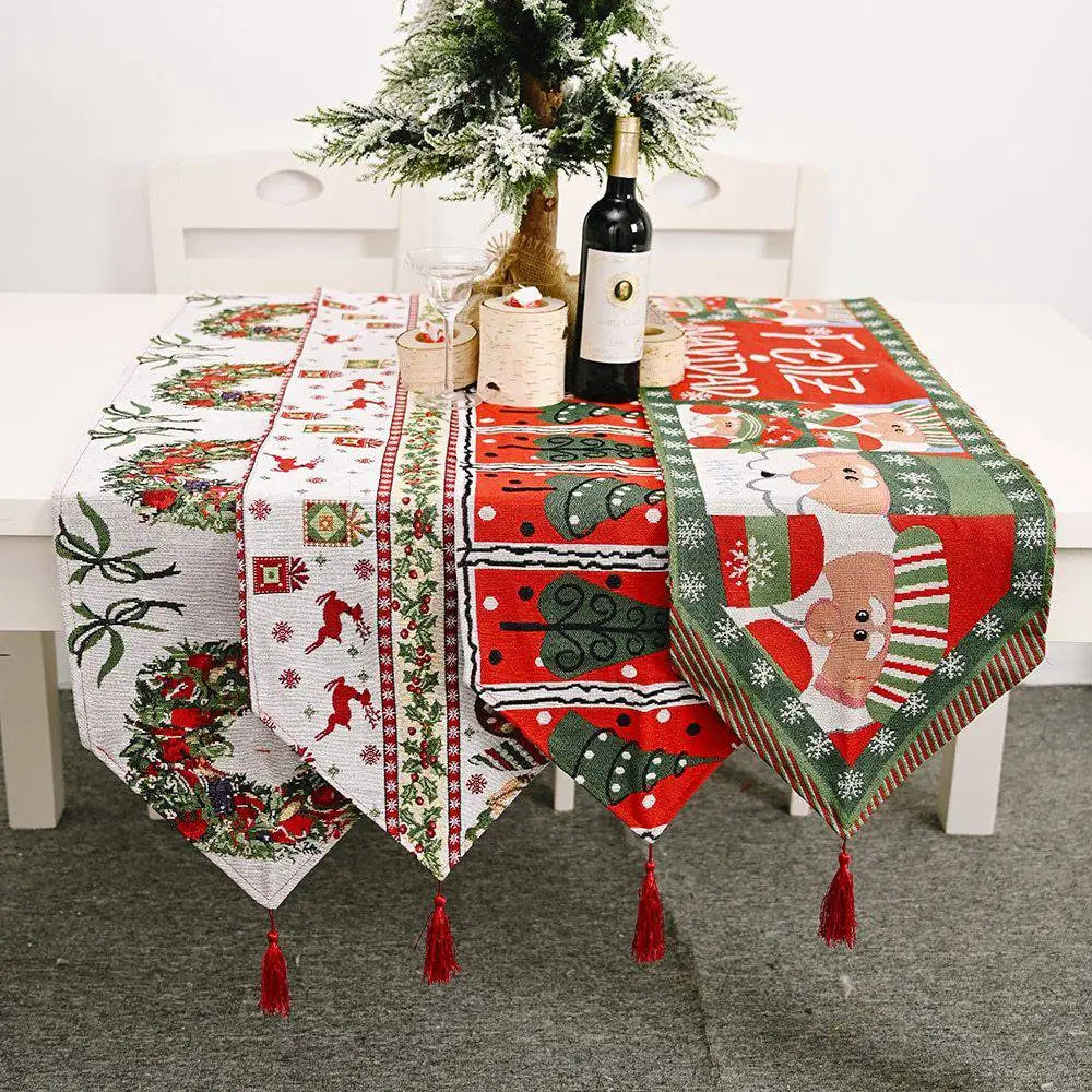 Woven christmas table runner in red green and white with festive patterns and matching red tassels for holiday decor