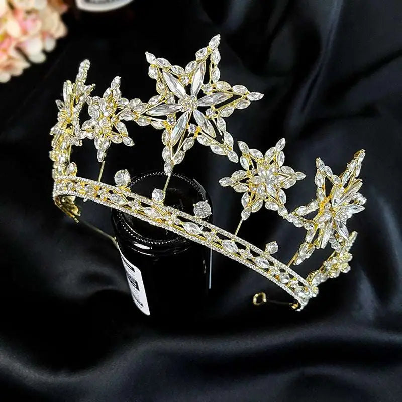 A sparkling gold xingx rhinestone fashion tiara crown with intricate crystal star and leaf designs embellished with clear crystals