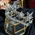 A xingx rhinestone fashion silver tiara crown with intricate crystal snowflake designs and a delicate beaded band