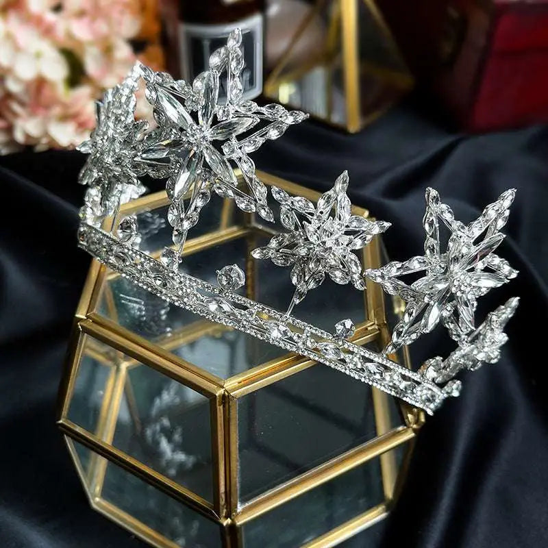 A xingx rhinestone fashion silver tiara crown with intricate crystal snowflake designs and a delicate beaded band