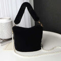 Black faux fur plush bucket bag with pearl chain design and plush handle for stylish everyday use