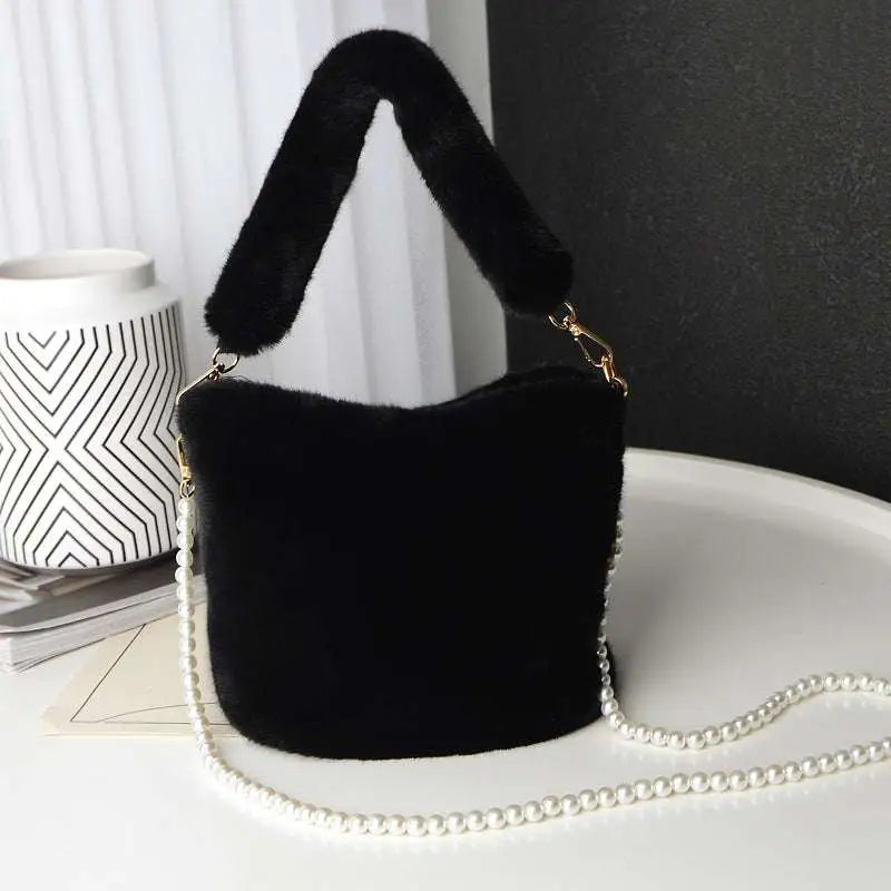 Black faux fur plush bucket bag with pearl chain design and plush handle for stylish everyday use