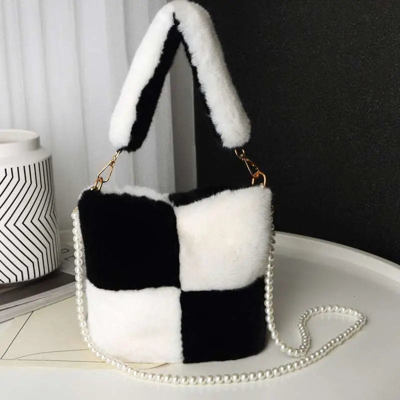 Black and white checkered plush bucket bag featuring a pearl chain design for stylish everyday use