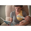 Yellow hands free baby bottle holder with clear bottle attached designed for convenient baby feeding support