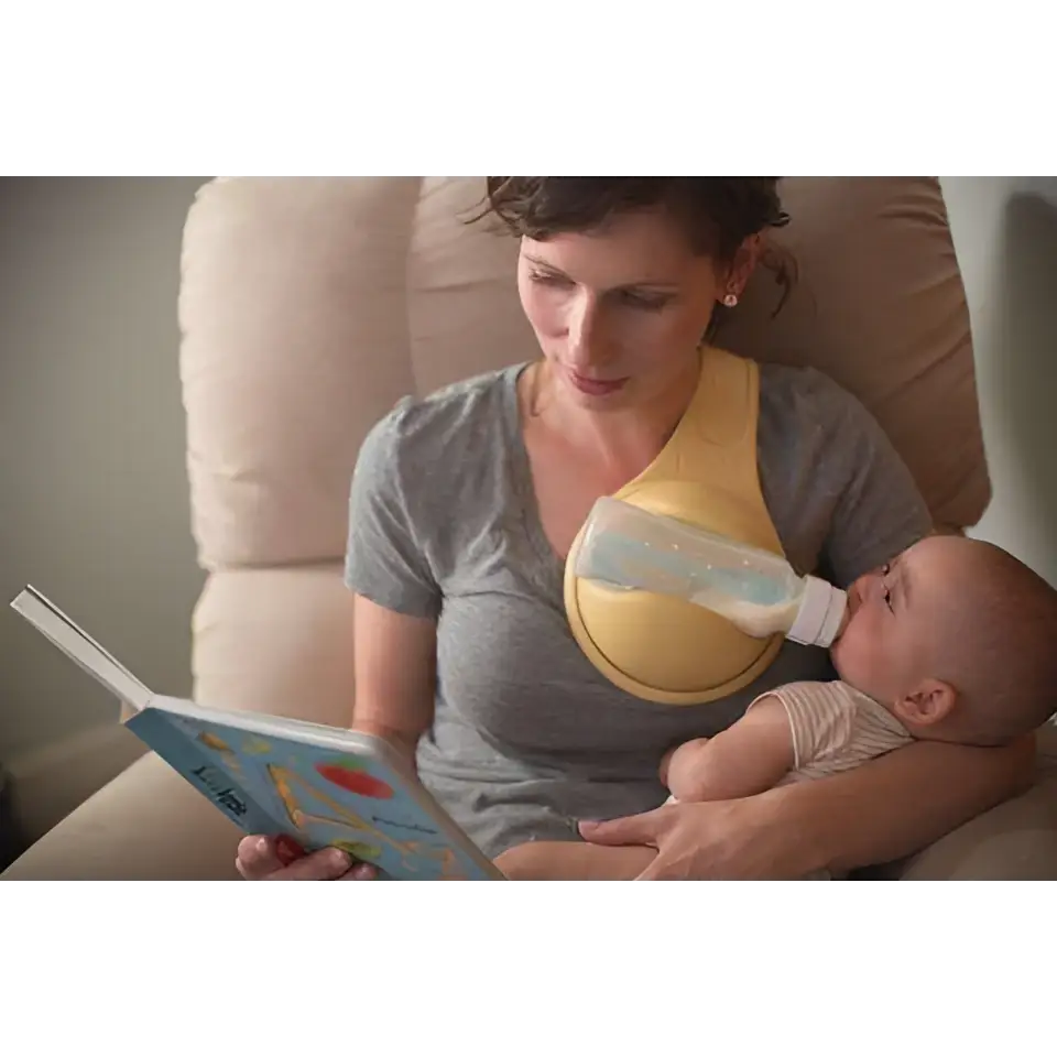 Yellow hands free baby bottle holder with clear bottle attached designed for convenient baby feeding support