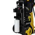 Yellow high pressure cleaning machine with retractable hose and white detergent tank for efficient pressure cleaning