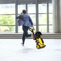Yellow and black kärcher pressure cleaning machine with wheels and retractable hose for efficient pressure cleaning
