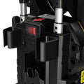 Black plastic power tool with red illuminated switch and silver accents attached to yellow pressure cleaning machine with retractable hose reel