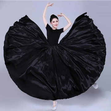 A flowing black satin solid color dance skirt with dramatic wide flare and smooth glossy texture for color performance skirt