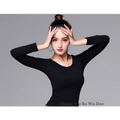 Black long sleeved fitted top paired with yellow satin solid color performance skirt for dance use