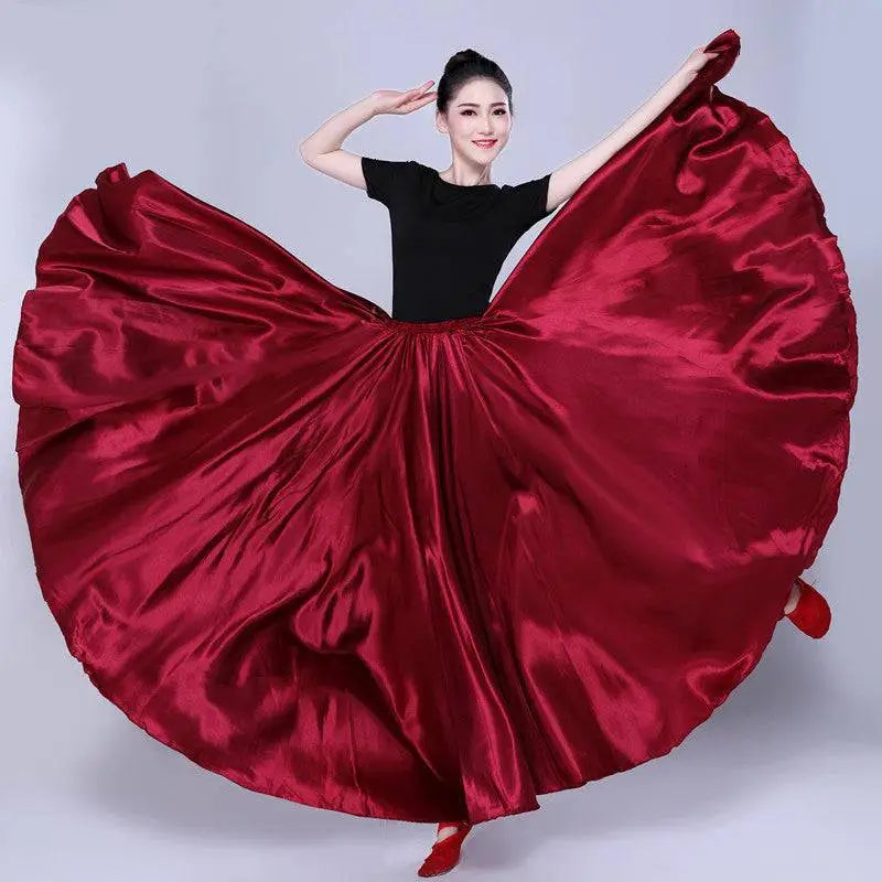 A deep red satin solid color dance skirt paired with a fitted black top and matching red shoes for performance use