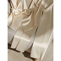 Cream-colored satin robe with matching bow belt showcasing youthful fashionable champagne western style elegance