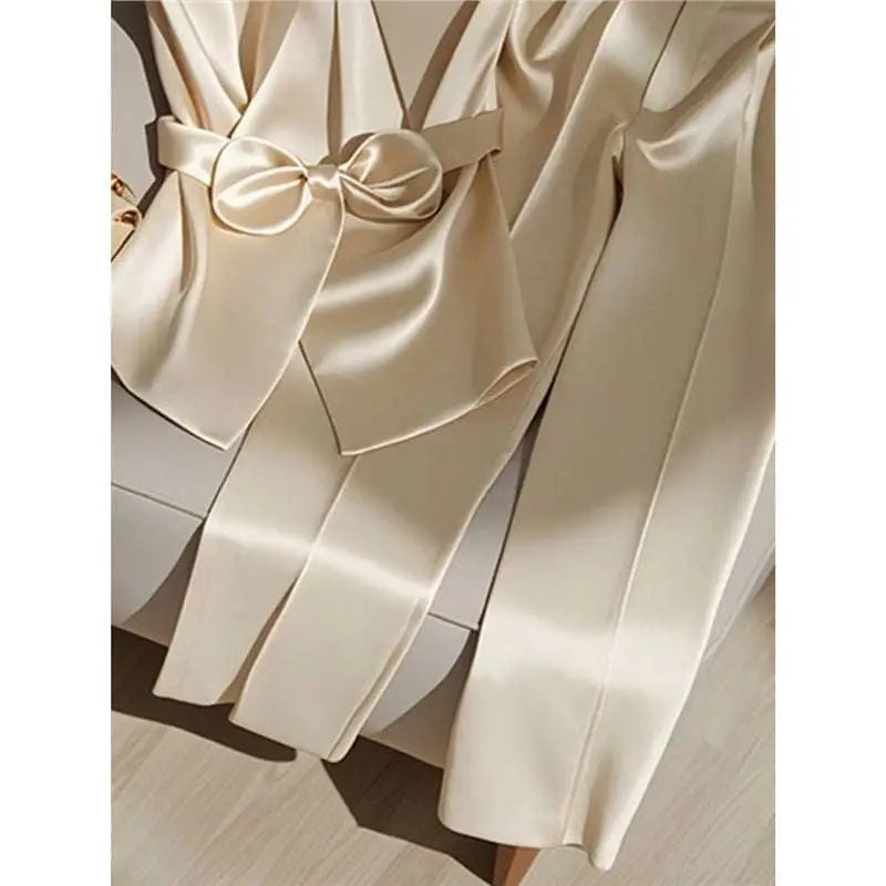 Cream-colored satin robe with matching bow belt showcasing youthful fashionable champagne western style elegance