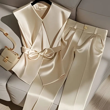 Cream satin pants with a sleek tailored fit and gold toned button detailing for youthful fashionable champagne style
