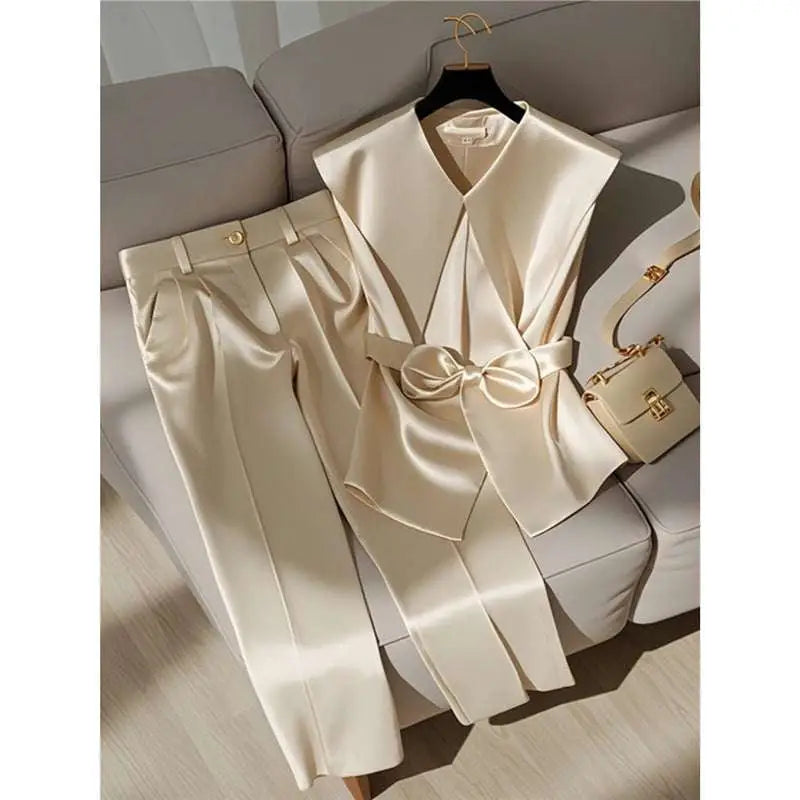 Cream satin sleeveless top with v-neck and front bow detail in youthful fashionable champagne western style clothing