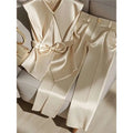 Youthful fashionable champagne cream satin sleeveless v-neck top with front bow and matching satin pants with gold button