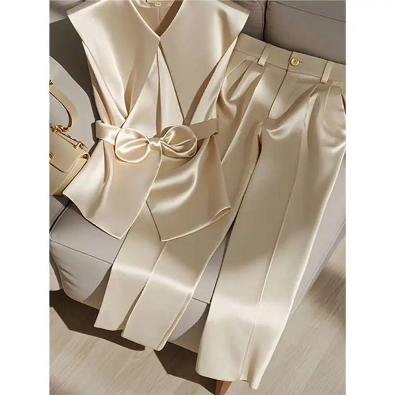 Youthful fashionable champagne cream satin sleeveless v-neck top with front bow and matching satin pants with gold button