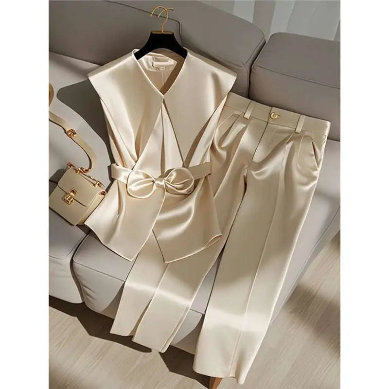 Cream satin sleeveless top with wide collar and front bow detail for youthful fashionable champagne outfits