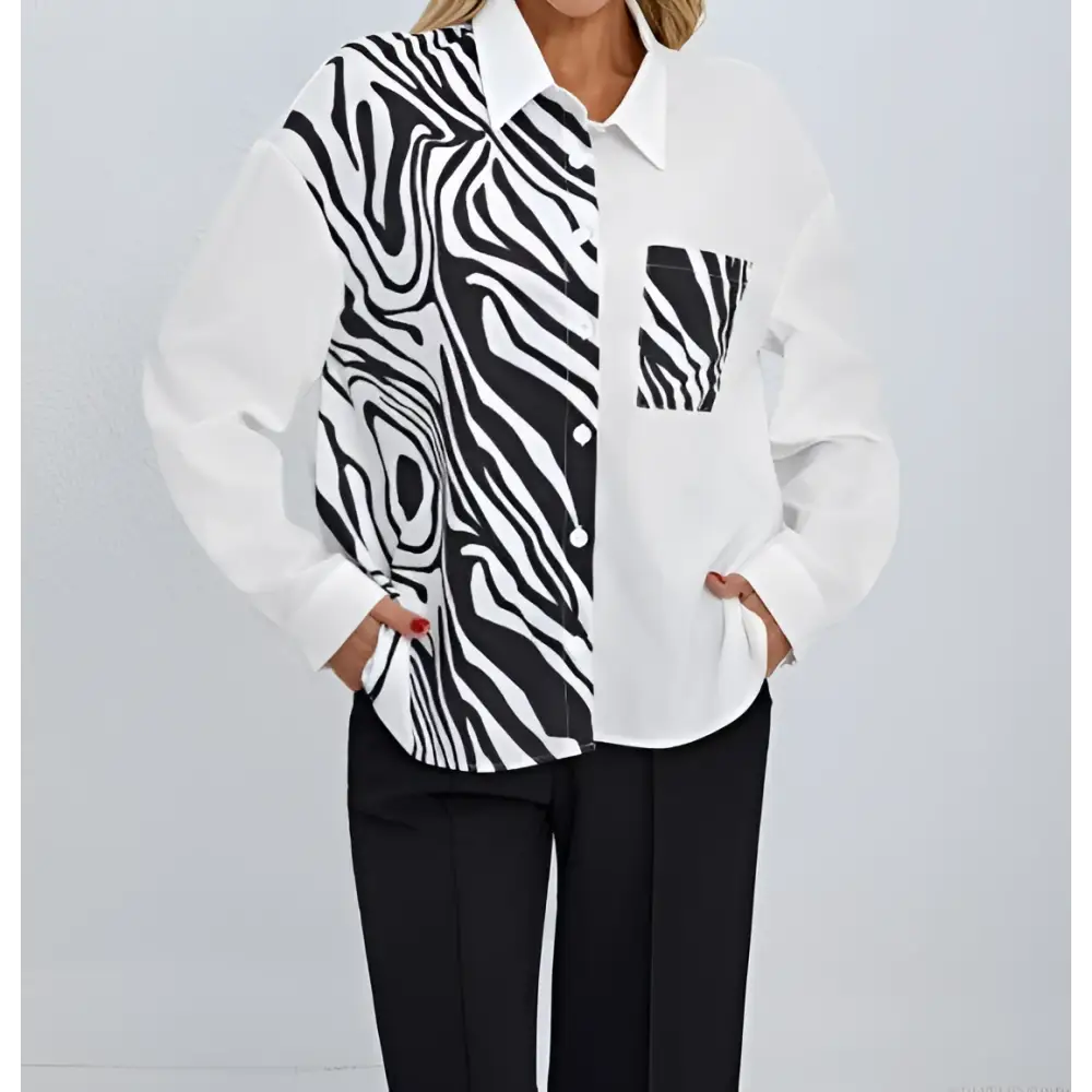 A stylish white zebra ladies collar print button chest pocket shirt with bold black and white zebra print detailing on one side