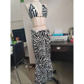 A black and white zebra printed bikini strappy skirt casual suit displayed on a mannequin in a two-piece set