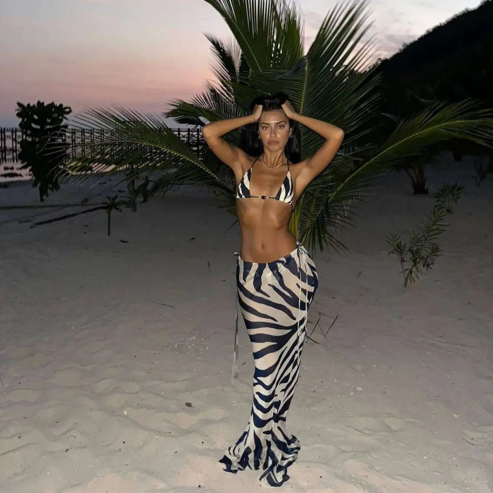 A zebra printed bikini with a triangle top and high-waisted flowing pants in a printed bikini strappy casual suit
