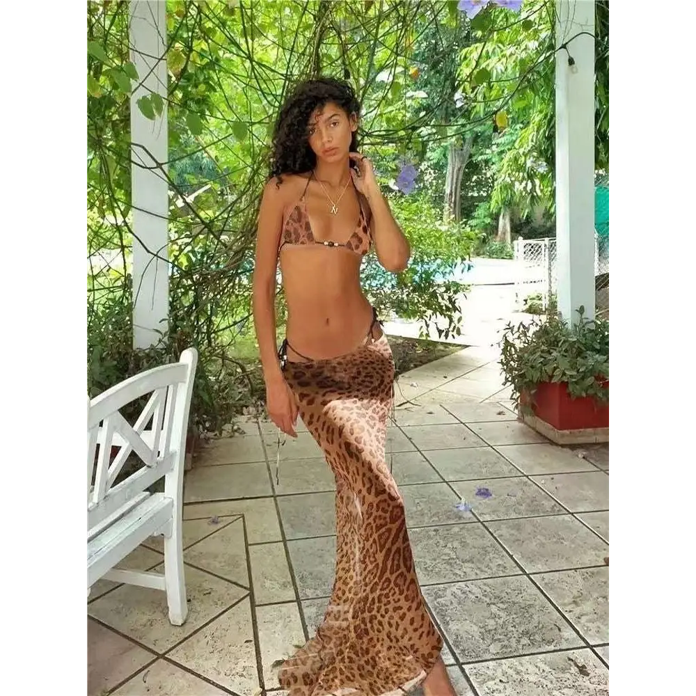A flowing leopard-print maxi strappy skirt with a high slit and frayed hem for a zebra printed bikini casual suit